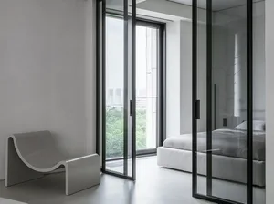 Modern minimalist bedroom featuring white furniture and glass walls.