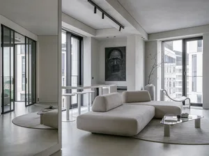 A modern residential living room with concrete and glass materials.