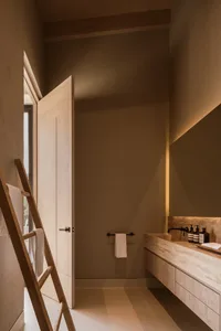 A minimalist bathroom with wooden accents and stone surfaces.