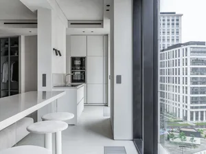 Modern white kitchen with minimalist design and sleek, contemporary aesthetic.