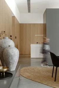 A modern minimalist interior featuring concrete surfaces and a sleek, contemporary design.
