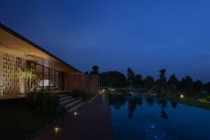 A modern house with exterior lighting at dusk.