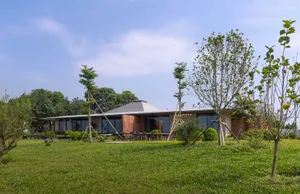 Modern residential building with wooden accents, glass windows, and concrete elements.