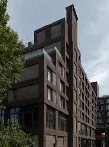 A modern building with a concrete exterior and glass windows.
