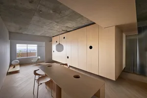 A minimalist apartment featuring wooden furniture.