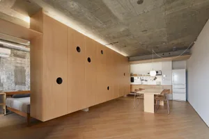 A modern residential kitchen featuring industrial wood accents with an open concept layout.