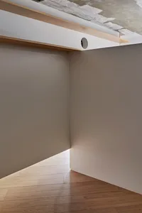 A minimalist interior design featuring a white floor and concrete wall.