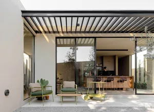Modern minimalist residential interior featuring exposed steel beams, glass walls, concrete flooring, and wood accents.