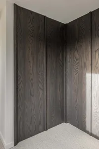 Modern, black, wooden closet system with sleek lines and a minimalist design.