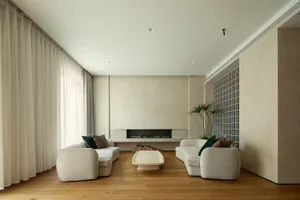 A modern living room featuring textured fabric sofas and a central coffee table.