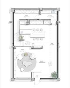 Floor plan of a modern living space with a neutral color palette, featuring a reading area, leisure area, and a kitchenette.