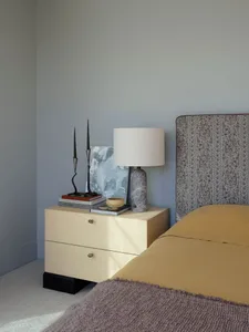 A minimalist bedroom featuring wood mix materials, including a bed with a floral-patterned headboard, a wooden nightstand, an