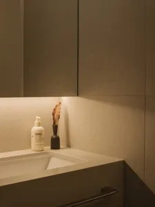 Modern, minimalist bathroom featuring concrete finishes and a sleek, contemporary design.