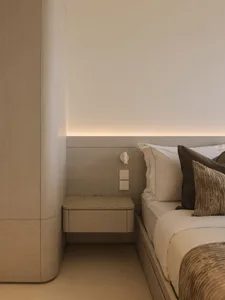 Modern minimalist bedroom featuring wood, marble, and fabric materials.