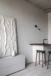 Modern residential kitchen with concrete finishes and minimalist design.