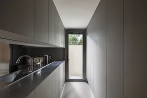 A sleek, modern kitchen with metallic countertops and minimalist design.