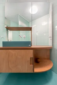 Minimalist bathroom with wood vanity and glass sink