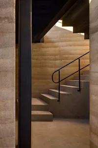 Concrete stairs with industrial lighting in an architectural setting.