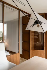 Modern home office featuring wood panels and white furniture.