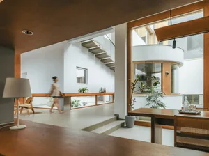 A contemporary space featuring concrete walls and floor, with a minimalist aesthetic and natural light.