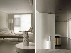 Modern living room with marble and concrete finishes, featuring sleek furniture and minimalist design.