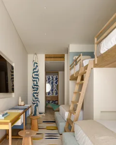 A modern Scandinavian apartment with light wood furniture, colorful textiles, and natural fabrics placed in the interior desi