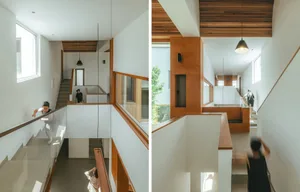 A modern interior space featuring a white concrete staircase with wooden accents.