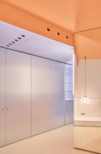 A minimalist bedroom featuring modern concrete walls and a white ceiling.