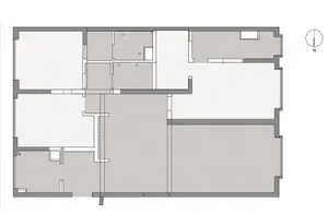 Minimalist apartment floor plan with white walls and black lines on paper.
