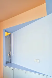 A minimalist interior design featuring glass walls and a geometric layout.