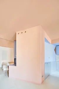 A minimalist apartment with pastel-colored walls and furniture