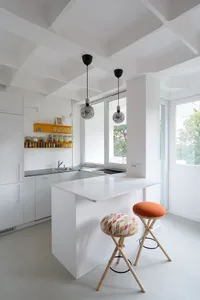 White, minimalist kitchen with a modern design.