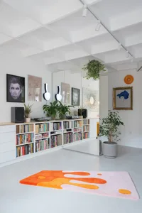 A minimalist living room featuring neutral tones and modern decor.