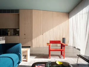 Minimalist living room with a pure wood design featuring sleek, geometric furniture and natural lighting.