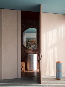 Modern bathroom with terrazzo flooring, wooden cabinets, and ceramic sink.