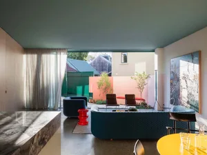Modern interior design featuring contemporary couches and chairs, colorful walls, and a view into an outdoor area.