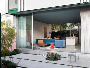 Modern living room featuring minimalist furniture and concrete materials.