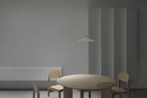 A modern minimalist dining room featuring a wooden dining table and chairs.