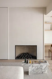 A modern minimalist living room featuring a marble fireplace and contemporary furniture