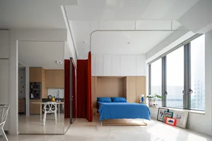 Modern minimalist living room featuring clean lines, wood and glass furniture, and a large window.