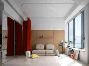 A modern living room featuring minimalist furniture, wooden paneling, and a mix of materials.