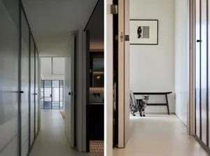 A modern minimalist interior with concrete flooring and glass partitions.