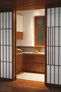 A modern white kitchen with wooden cabinets and a white countertop.