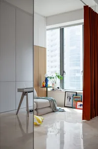 A modern living room featuring a marble floor and paneled cabinetry.