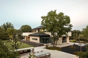 A modern residential home featuring concrete, glass, and metal materials.