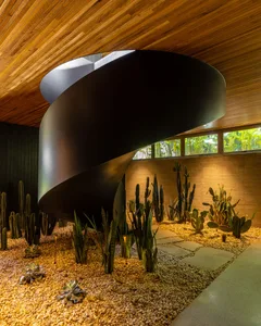 Spiral staircase with black metal railing in a minimalist interior
