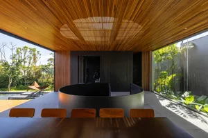 A modern interior space featuring wooden walls and concrete elements.