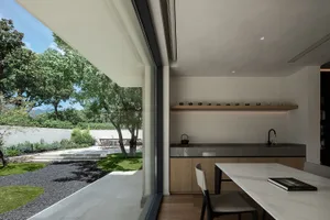Modern kitchen and dining area with concrete finishes and minimalist design