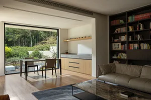 Modern living room with wooden floors and integrated kitchen area