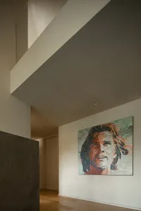 An abstract portrait painting displayed on a wall.